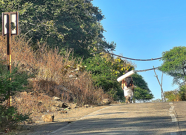 A pilgrim walking towards MANDU