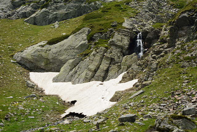 Bulgaria, Tiny Waterfall and Remnants of Snow in the "Rila Lakes" Circus