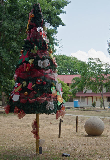 Ancient stone sphere and Christmas tree