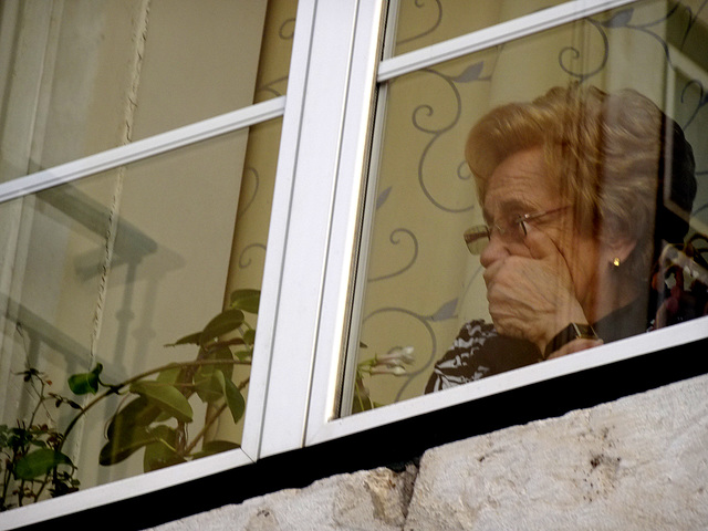 She's  watching a group of young people sitting on a terrace ..