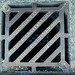 Diagonal manhole cover in Carrbridge