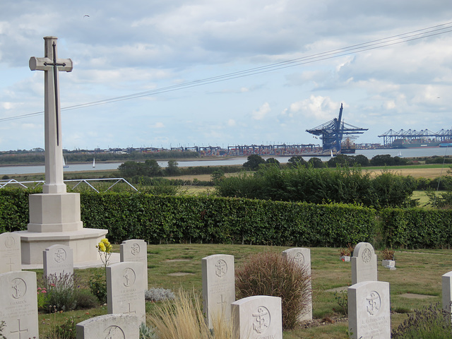 shotley church, suffolk (22) view across c20 naval graves past blomfield's war memorial cross to felixstowe docks