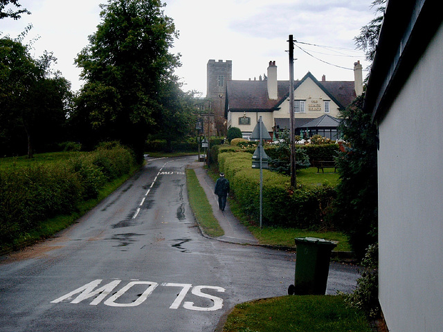 Main Street, the Black Horse and the Church of St Andrew at Foxton,