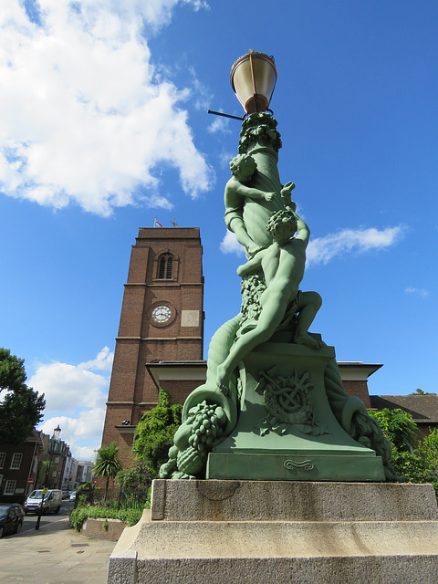 chelsea old church, london (109) the late c17 brick tower had to be rebuilt after wwii; in the foreground a bronze lamp standard commemorates bazalgette's c19 chelsea embankment