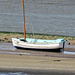 Solitary boat beached on the river bank