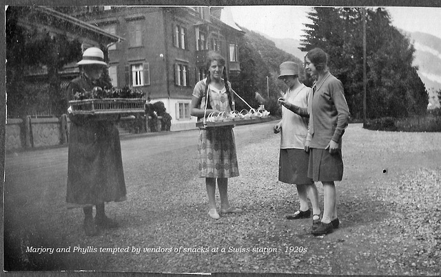 Marjory and Phyllis tempted by vendors of snacks at a Swiss station - 1920s