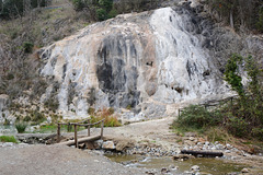 Italy, Bagni di San Filippo, Lime Deposits and Small Wooden Bridge over the Stream