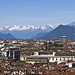 Turin from the top of the bell tower of the St. John Baptist Cathedral - From the rooftops and innumerable skylights of the city to the Susa Valley (To the left on the spur, one can see the Sacra of San Michele)