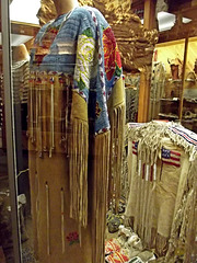 Sioux woman's dress and man's jacket (right)