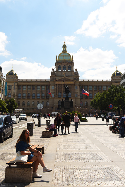 Lady sitting on a bench in Prague