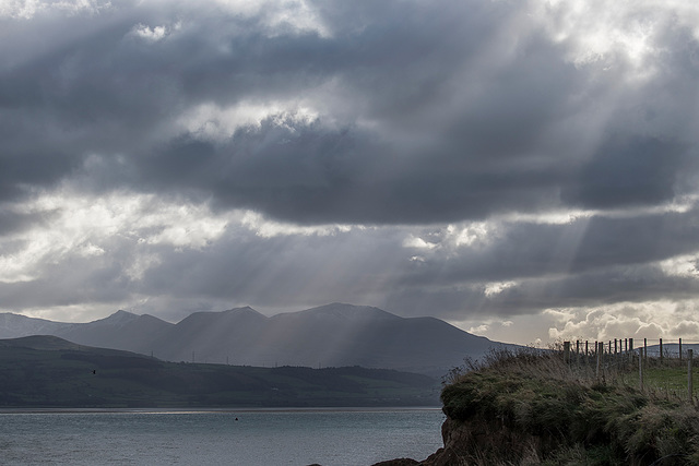 Shafts of light hitting the Welsh hills