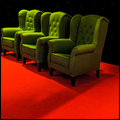 3 chairs on a red carpet