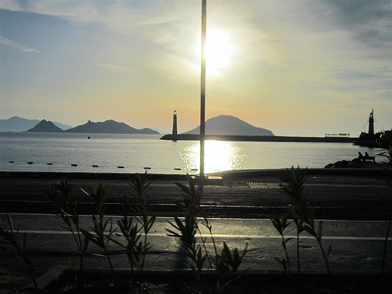 Hazy sun behind the islands surrounding Turgetries