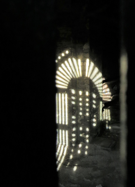 brompton cemetery , london,shadow of 1840s cast iron gates in the catacombs