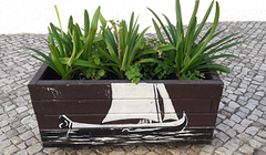 Street art on flower bed.