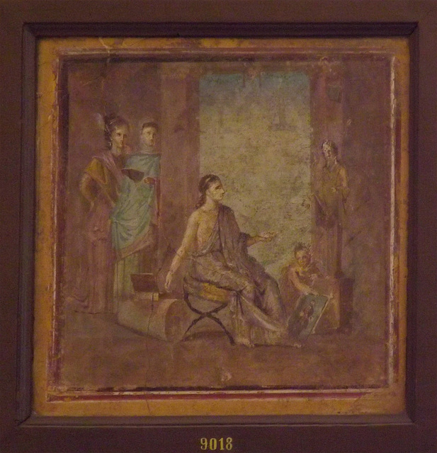 Wall Painting with a Female Painter with a Finished Painting of Priapus from the House of the  Surgeon in Pompeii in the Naples Archaeological Museum, July 2012