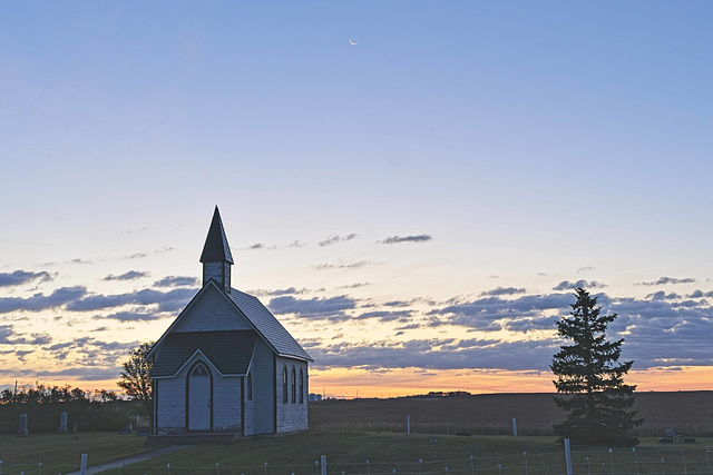 a crescent moon and country church