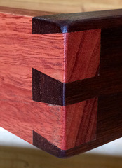Detail of dovetail joint between light and dark Jarrah wood (swan river mahogany) frame.
