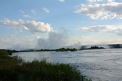 Zambia, The Calm Flow of the Zambezi River and the Water Dust of Victoria Falls ahead