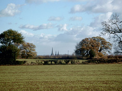 The three spires of Lichfield Cathedral come into view from near The Abnalls.