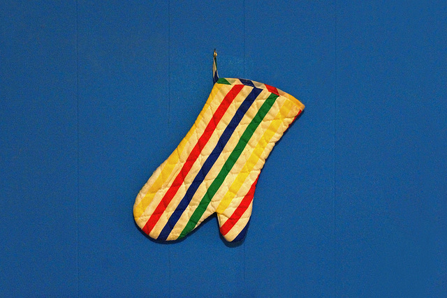 One Striped Oven Mitt Hanging On A Bedroom Wall
