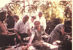 Grandma practices her "boarding house reach" as other family members also fill plates, August, 1961.
