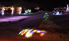 The strange effect of Christmas Lights under the snow.