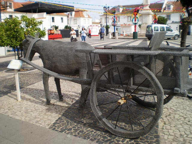 Sculpture of donkey pulled cart.