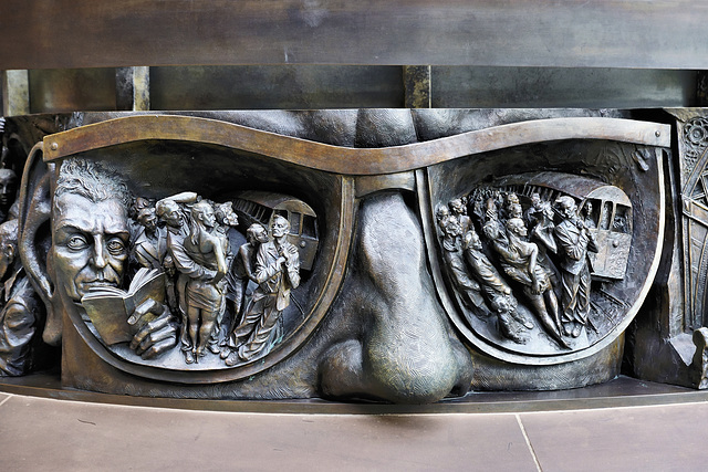 In the Eye of the Beholder – Frieze below the "Meeting Place" Statue, St Pancras Railway Station, Euston Road, London, England