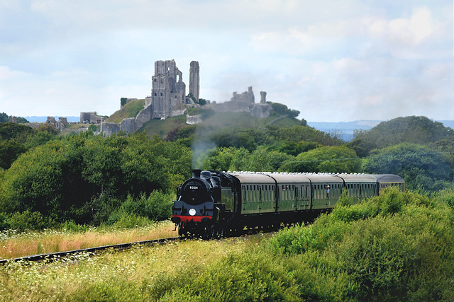 Steam train passing Corfe Castle