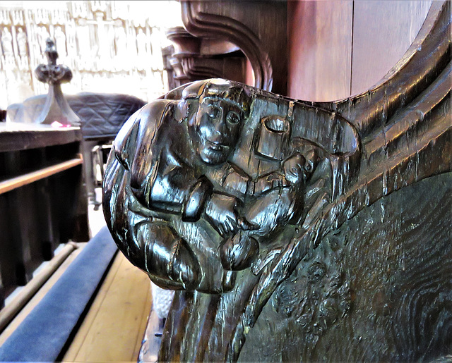 boston church,lincs (69)c14 stalls elbow man with dog