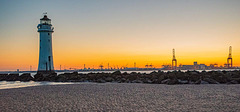 Pech Rock lighthouse, New Brighton with Liverpool docks in the background