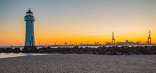 Pech Rock lighthouse, New Brighton with Liverpool docks in the background