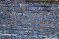 Wall cladding made of whisky barrel staves cut into short lengths.