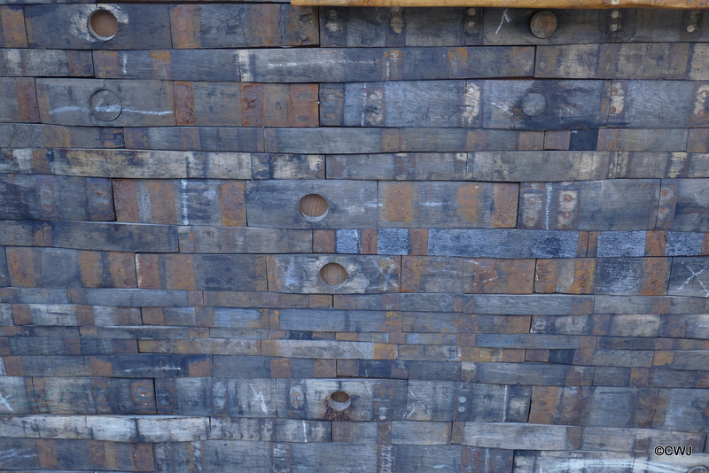 Wall cladding made of whisky barrel staves cut into short lengths.
