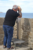 Man with telescope in St Malo