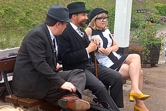 Three respectable people sitting on a bench! Three respectable people sitting on a bench!