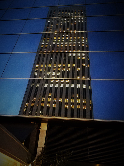 Torre Picasso reflected at night.