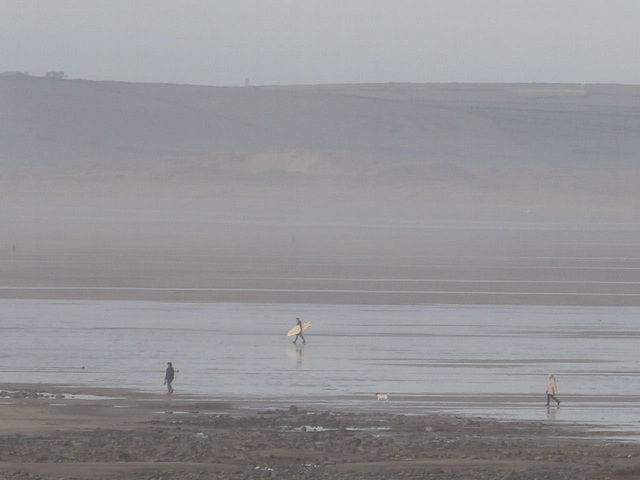 The lone surfer walking to the sea