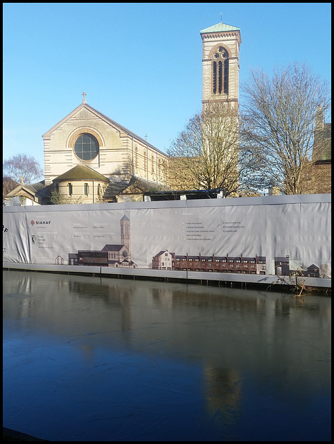 fenced-off canalside church