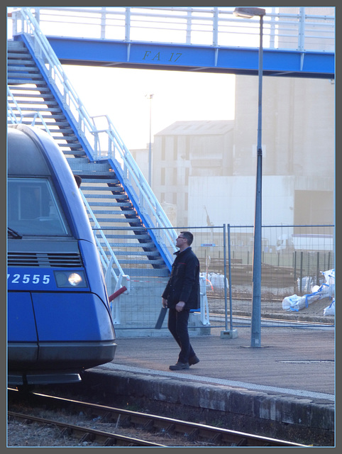 Man in Black in blue station...