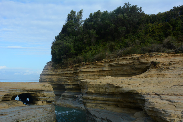 Greece, Northern Kerkyra (Corfu), Holes in the Coastal Sandstone Cliffs Created by Air and Water