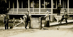 Men, Women, Dogs, and Guns in Front of a House (Cropped)