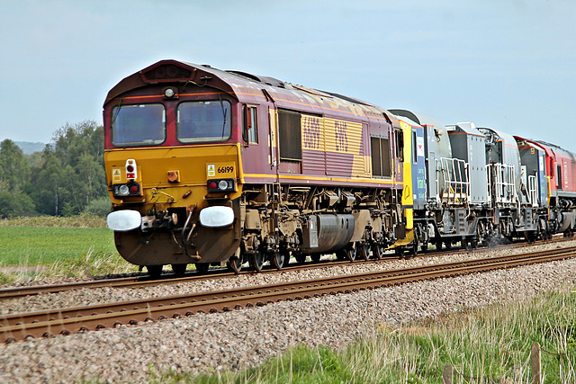 DB Cargo UK class 66 in EWS livery 66199 on rear of 3Z12 09.25 Knottingley T.M.D - Knottingley  T.M.D weedkiller train at Willerby Carr Crossing 3rd May 2020.