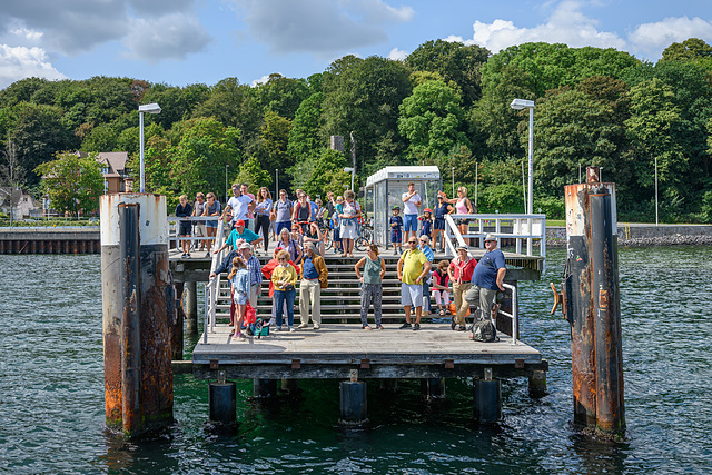 Colourful people waiting for the ferry