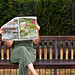 Sitting on bench reading newspaper!