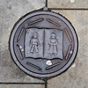 Decorative iron plaque in the pavement