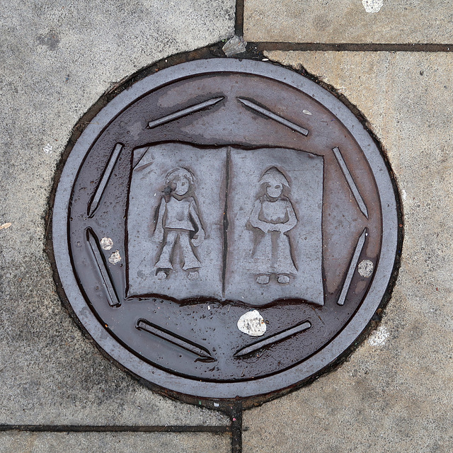 Decorative iron plaque in the pavement