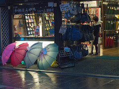 Umbrella shop on a rainy night