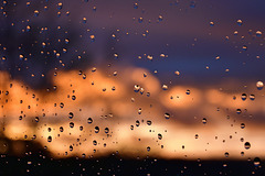 Raindrops on a window at sunset